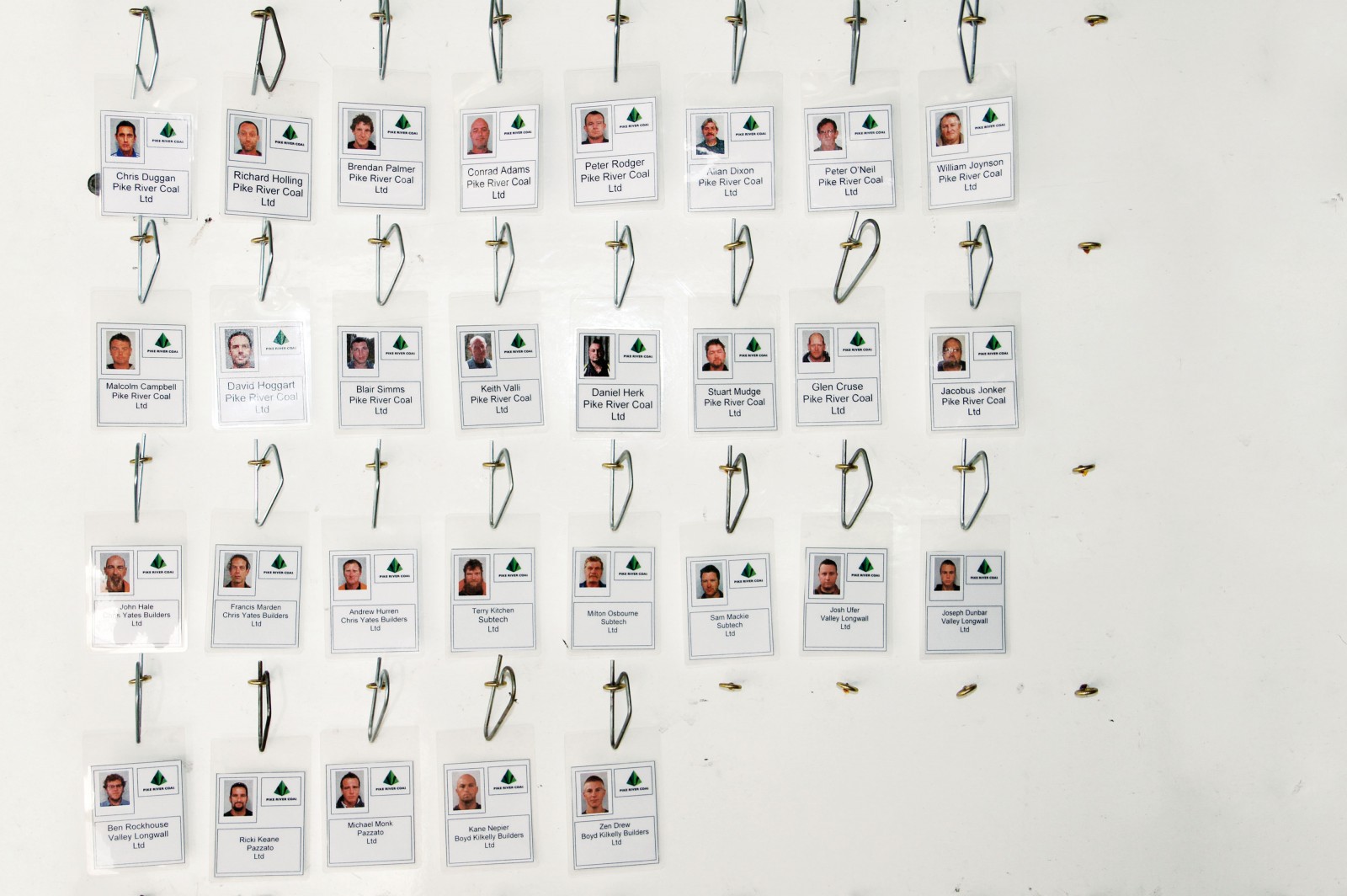 107_atimetoremember_bodyimage Faces of the 29 men trapped in the Pike River Coal Mine stare from a tag board—a system used to keep track of who is underground at any given time.