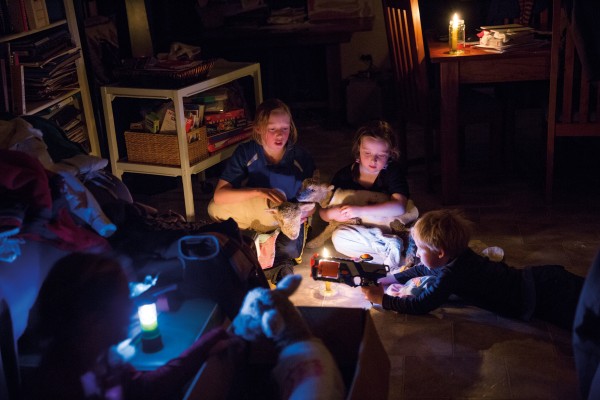 Margot, Ruby and Annie Ferguson tend their adopted lambs by candlelight after a storm knocked out power to their home, while Gus Ferguson plays next to them. This year was Margot’s last attending the Kahutara School pet day before heading to intermediate school. Raising a lamb is not about winning awards, she says, but spending time with them and watching them grow.